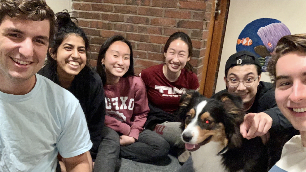 Group photo of wellbeing ambassadors in MacGregor with a dog. 